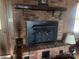 Brick fireplace with wood mantel and black insert at 16480 Indian Mound Rd, Norwood, NC 28128