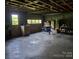 Spacious garage workshop featuring a garage door and large table with chairs at 16480 Indian Mound Rd, Norwood, NC 28128