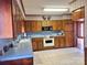 Traditional kitchen featuring wood cabinets, blue countertops, and classic appliances at 16480 Indian Mound Rd, Norwood, NC 28128
