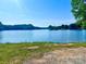 Scenic lake view with calm blue water and lush green trees in the background at 16480 Indian Mound Rd, Norwood, NC 28128