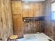 Functional laundry room with wooden cabinets, utility connections, and linoleum flooring at 16480 Indian Mound Rd, Norwood, NC 28128
