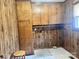 Laundry room with wood cabinets and built-in shelving at 16480 Indian Mound Rd, Norwood, NC 28128