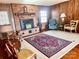 Living room with brick fireplace, wood paneling and hardwood floors at 16480 Indian Mound Rd, Norwood, NC 28128