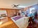 Living room with wood paneling, fireplace, and hardwood floors at 16480 Indian Mound Rd, Norwood, NC 28128