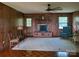Cozy living room with a brick fireplace and wood paneling at 16480 Indian Mound Rd, Norwood, NC 28128