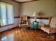 Cozy living room with patterned wallpaper, hardwood floors, and two comfortable armchairs at 16480 Indian Mound Rd, Norwood, NC 28128