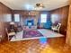 Living room with brick fireplace, wood paneling and hardwood floors at 16480 Indian Mound Rd, Norwood, NC 28128