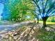 Scenic view of property with mature trees and a winding driveway at 16480 Indian Mound Rd, Norwood, NC 28128