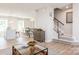 Light and airy living room with hardwood floors and stairs at 1805 Woodlands Pointe Dr, Charlotte, NC 28216