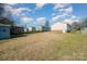 Large backyard with shed and neighboring houses at 222 E Alabama Ave, Bessemer City, NC 28016