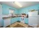 Updated kitchen with light blue cabinets and modern appliances at 222 E Alabama Ave, Bessemer City, NC 28016