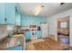 Updated kitchen with light blue cabinets and modern appliances at 222 E Alabama Ave, Bessemer City, NC 28016