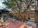 Landscaped backyard with brick patio and wrought iron gate at 232 Perrin Pl, Charlotte, NC 28207