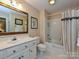 Clean bathroom with a bathtub, shower, and updated vanity at 232 Perrin Pl, Charlotte, NC 28207