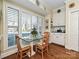 Bright breakfast room features built-in cabinetry and a glass-top table with seating for four at 232 Perrin Pl, Charlotte, NC 28207