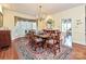 Formal dining room with hardwood floors, large windows, and a chandelier at 232 Perrin Pl, Charlotte, NC 28207