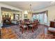 Sunlit dining room featuring hardwood floors, bay window, and access to living room at 232 Perrin Pl, Charlotte, NC 28207