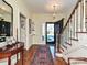 Elegant entryway showcasing hardwood floors, a grand staircase, and a view to the living room at 232 Perrin Pl, Charlotte, NC 28207