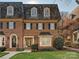 Brick front exterior of charming townhome with a gabled roof and manicured lawn at 232 Perrin Pl, Charlotte, NC 28207