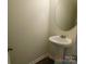 Small powder room with pedestal sink and mirror at 274 Village Creek Way, Salisbury, NC 28147