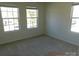 Bright bedroom with three windows and neutral carpeting at 274 Village Creek Way, Salisbury, NC 28147