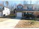 Two-story townhome with stone accents and a driveway at 274 Village Creek Way, Salisbury, NC 28147