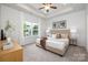 Main bedroom with plush carpet, large window, and neutral color scheme at 5513 Skycrest Dr, Charlotte, NC 28269