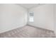 Simple bedroom with neutral walls and carpeted floor at 5513 Skycrest Dr, Charlotte, NC 28269