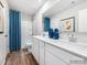 Main bathroom with double vanity, white cabinets, and blue shower curtain at 1070 Old Trade St, Edgemoor, SC 29712