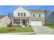 Two-story house with stone and siding accents, a two-car garage, and a well-manicured lawn at 1070 Old Trade St, Edgemoor, SC 29712