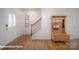 Inviting foyer with hardwood floors, coat rack with bench, and staircase leading to the upper level at 126 Rustling Waters Dr, Mooresville, NC 28117
