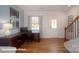 Bright office space with hardwood floors, large desk, and natural light, ideal for remote work at 126 Rustling Waters Dr, Mooresville, NC 28117
