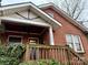 Brick home with porch and mature landscaping at 1645 Lombardy Cir, Charlotte, NC 28203