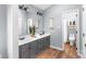 Updated bathroom with double vanity and gray cabinets at 2124 Caleo Cir, Charlotte, NC 28270