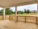 The new home has a spacious, covered back porch with a wooden railing and serene views at 320 Triple Ponds Ct, Clover, SC 29710