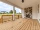 Covered porch with an outdoor fireplace featuring stone veneer at 320 Triple Ponds Ct, Clover, SC 29710