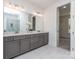 This bathroom features gray cabinets, double sinks, a separate toilet, and large mirrors at 320 Triple Ponds Ct, Clover, SC 29710