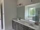 Elegant bathroom with dual sinks, modern vanity, and a large mirror, offering style and functionality at 320 Triple Ponds Ct, Clover, SC 29710