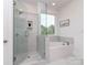 This bathroom features a walk-in shower, soaking tub, and white marble tile at 320 Triple Ponds Ct, Clover, SC 29710