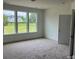 Well-lit bedroom with plush carpet, large windows, and a serene view, creating a comfortable retreat at 320 Triple Ponds Ct, Clover, SC 29710