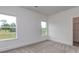 Bedroom featuring neutral carpet, white walls, two windows, and a view of outside greenery at 320 Triple Ponds Ct, Clover, SC 29710