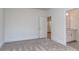A bedroom with neutral walls and carpet leading to a bathroom at 320 Triple Ponds Ct, Clover, SC 29710