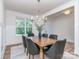 Elegant dining area with a modern chandelier and views of the backyard at 320 Triple Ponds Ct, Clover, SC 29710