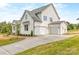 Stylish home with a three-car garage and a concrete driveway at 320 Triple Ponds Ct, Clover, SC 29710