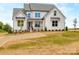 Beautiful two-story home featuring a quaint front porch and professionally landscaped yard at 320 Triple Ponds Ct, Clover, SC 29710