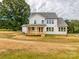 Exterior view of a two-story home featuring a covered porch and a well-maintained yard at 320 Triple Ponds Ct, Clover, SC 29710