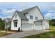 Beautiful home featuring a three-car garage, a well-maintained lawn, and a concrete driveway at 320 Triple Ponds Ct, Clover, SC 29710