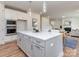 This spacious kitchen features white cabinets, stainless steel appliances, and a large island with bar seating at 320 Triple Ponds Ct, Clover, SC 29710