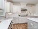 This spacious kitchen features white cabinets, stainless steel appliances, and a large island with bar seating at 320 Triple Ponds Ct, Clover, SC 29710