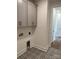 Well-lit laundry room with gray cabinetry and decorative tile flooring, plus washer/dryer hookups at 320 Triple Ponds Ct, Clover, SC 29710